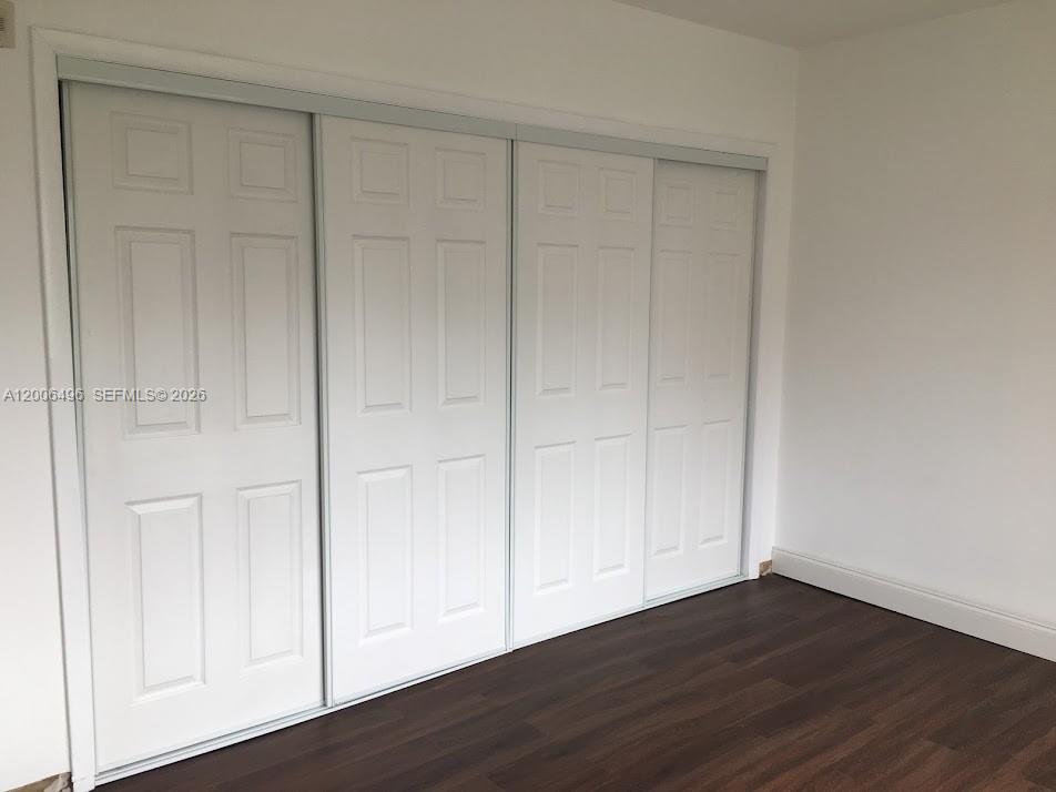 900 Southwest 84th Avenue, Unit 415D Miami, FL 33144 - Photo 12 of 19 a view of an empty room with wooden floor