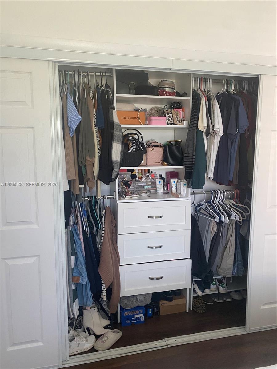 900 Southwest 84th Avenue, Unit 415D Miami, FL 33144 - Photo 13 of 19 a view of walk in closet with clothes