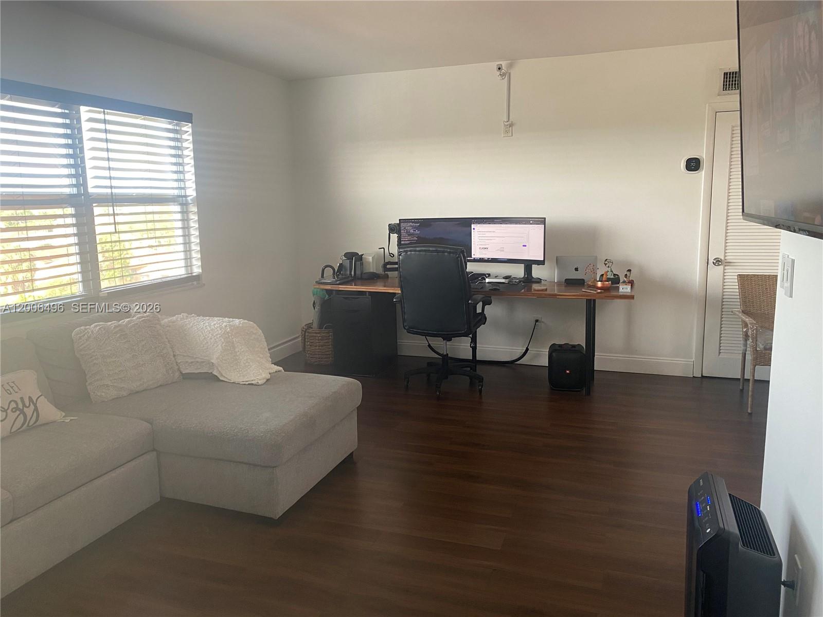 900 Southwest 84th Avenue, Unit 415D Miami, FL 33144 - Photo 14 of 19 a work room with furniture and wooden floor