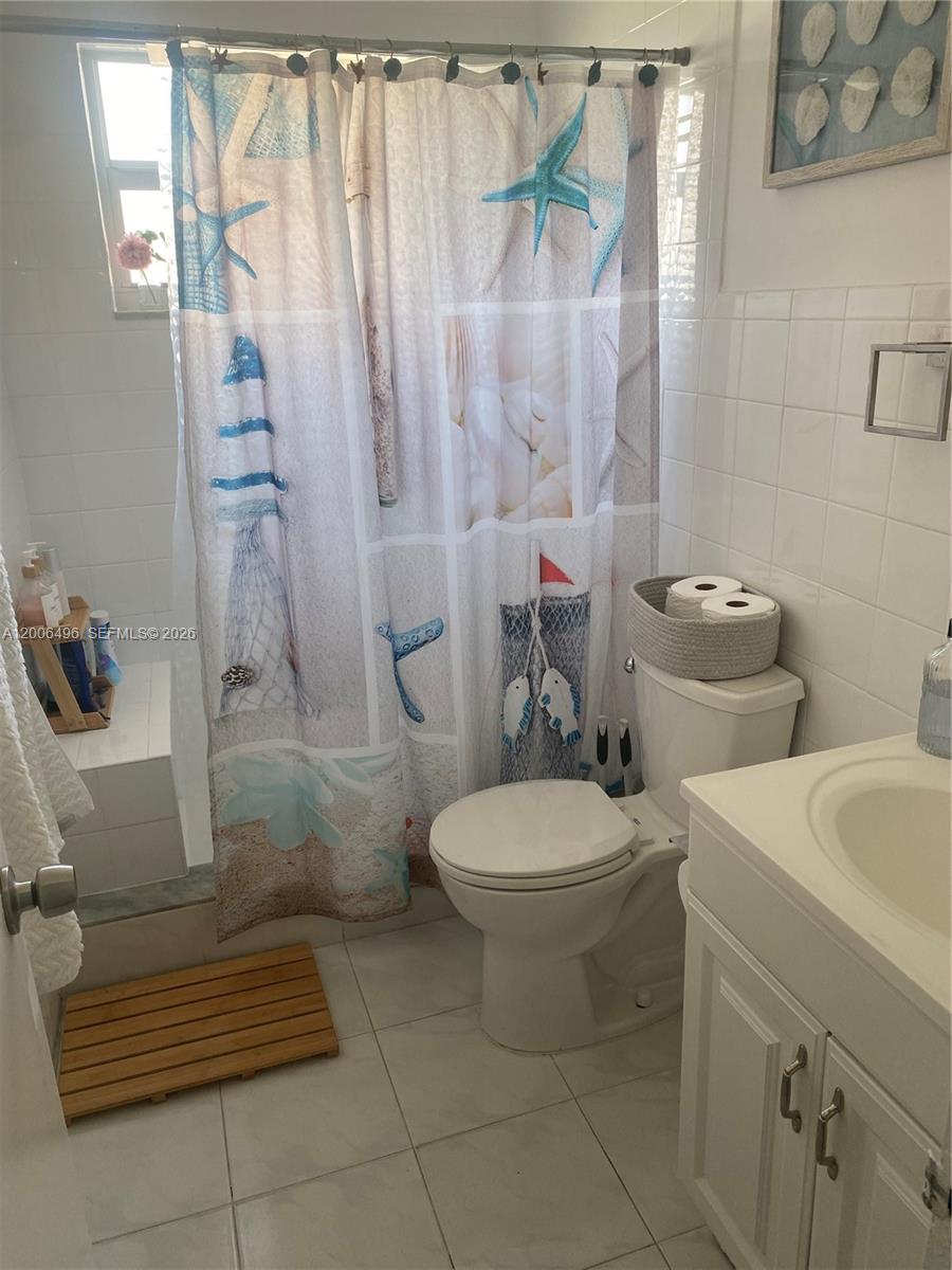 900 Southwest 84th Avenue, Unit 415D Miami, FL 33144 - Photo 15 of 19 a bathroom with a toilet and a shower