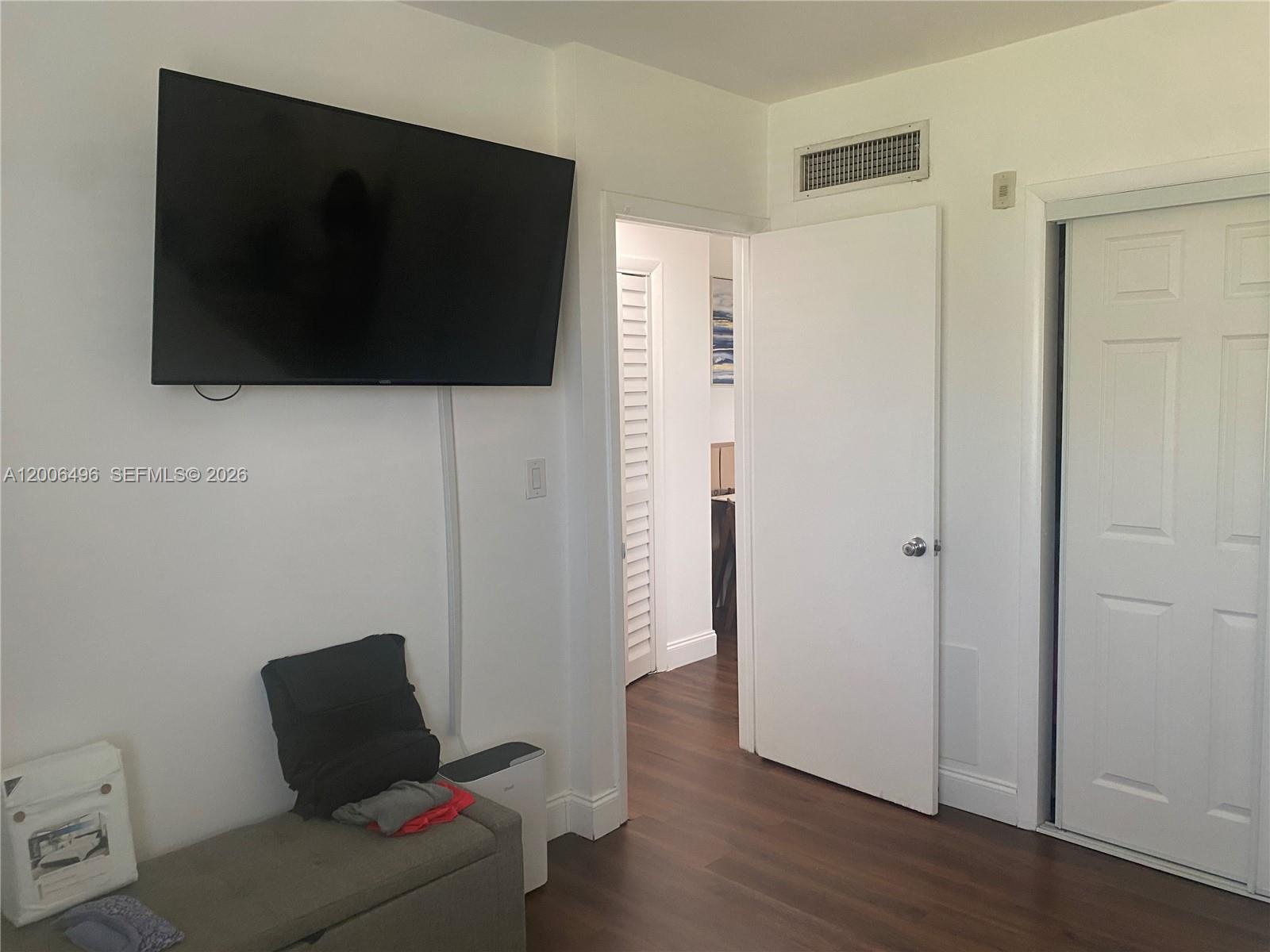 900 Southwest 84th Avenue, Unit 415D Miami, FL 33144 - Photo 17 of 19 a living room with a flat screen tv and a couch