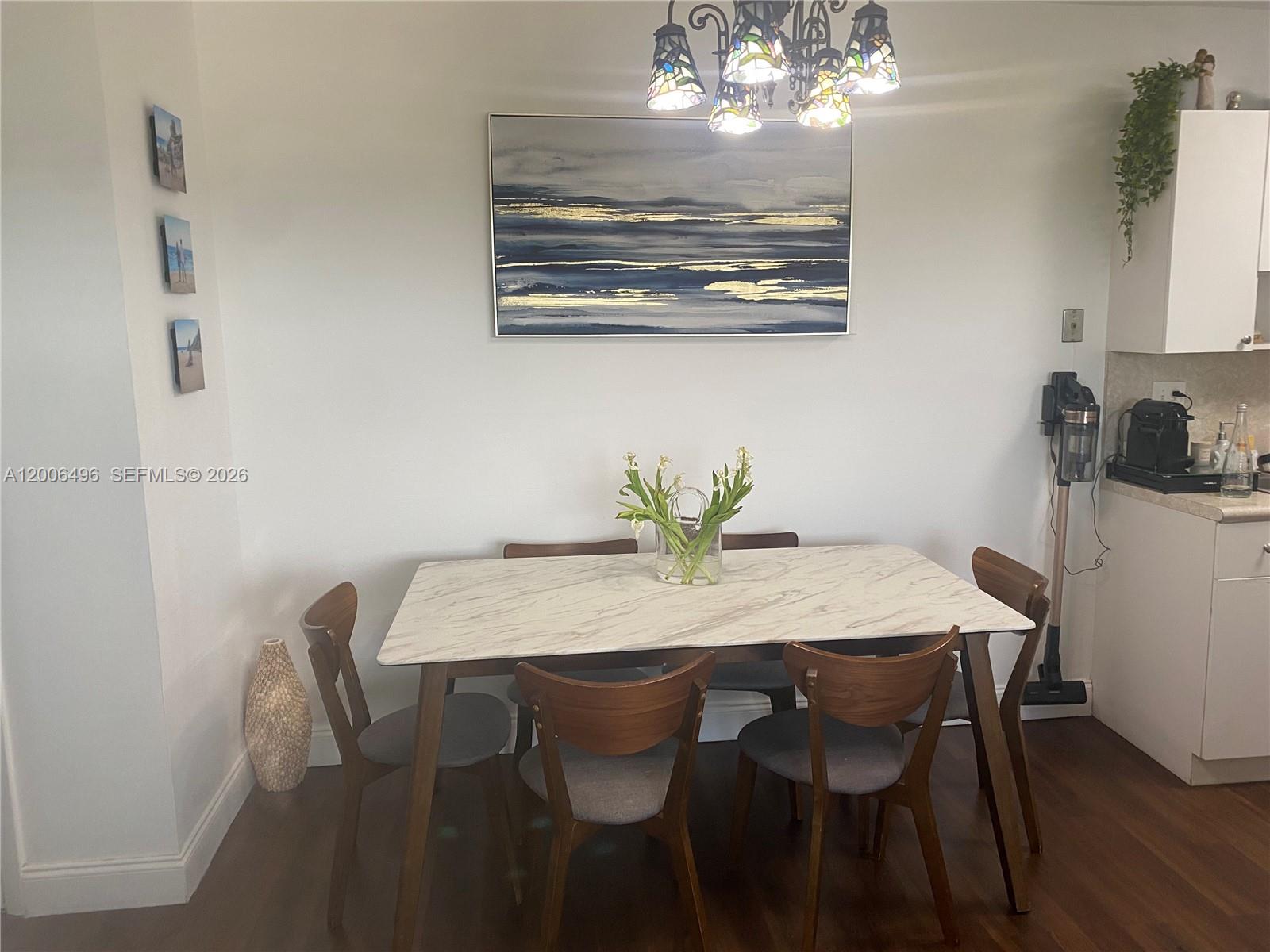 900 Southwest 84th Avenue, Unit 415D Miami, FL 33144 - Photo 9 of 19 a view of a dining room with furniture and chandelier