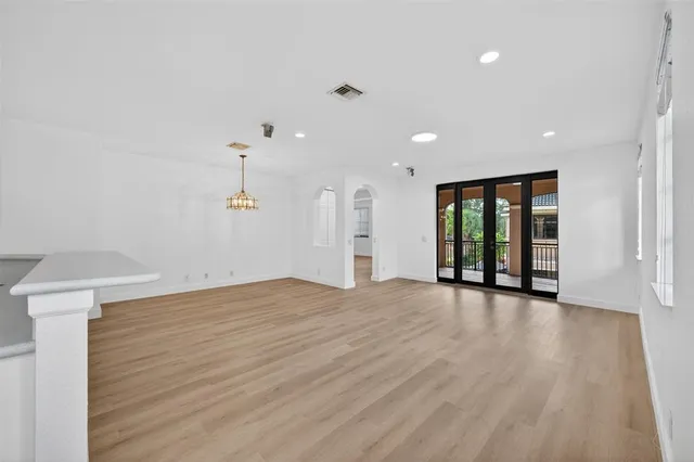 a kitchen with white cabinets and sink