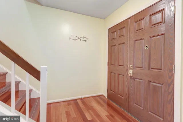 a view of empty room with wooden floor and fireplace