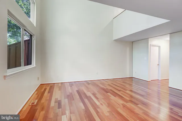 a bathroom with a granite countertop toilet sink and mirror