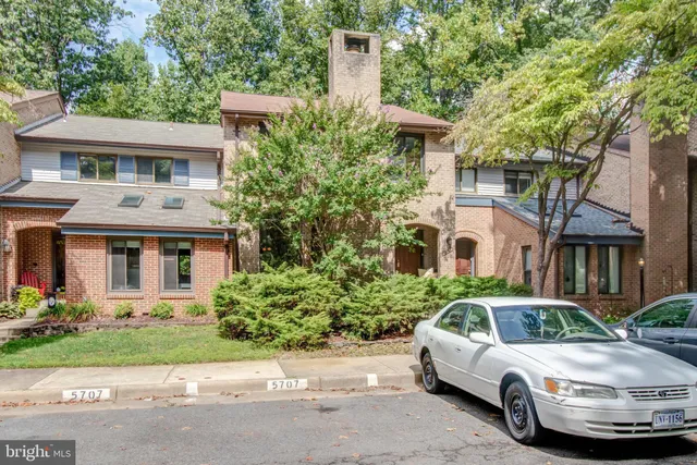 a front view of a house with a garden and plants