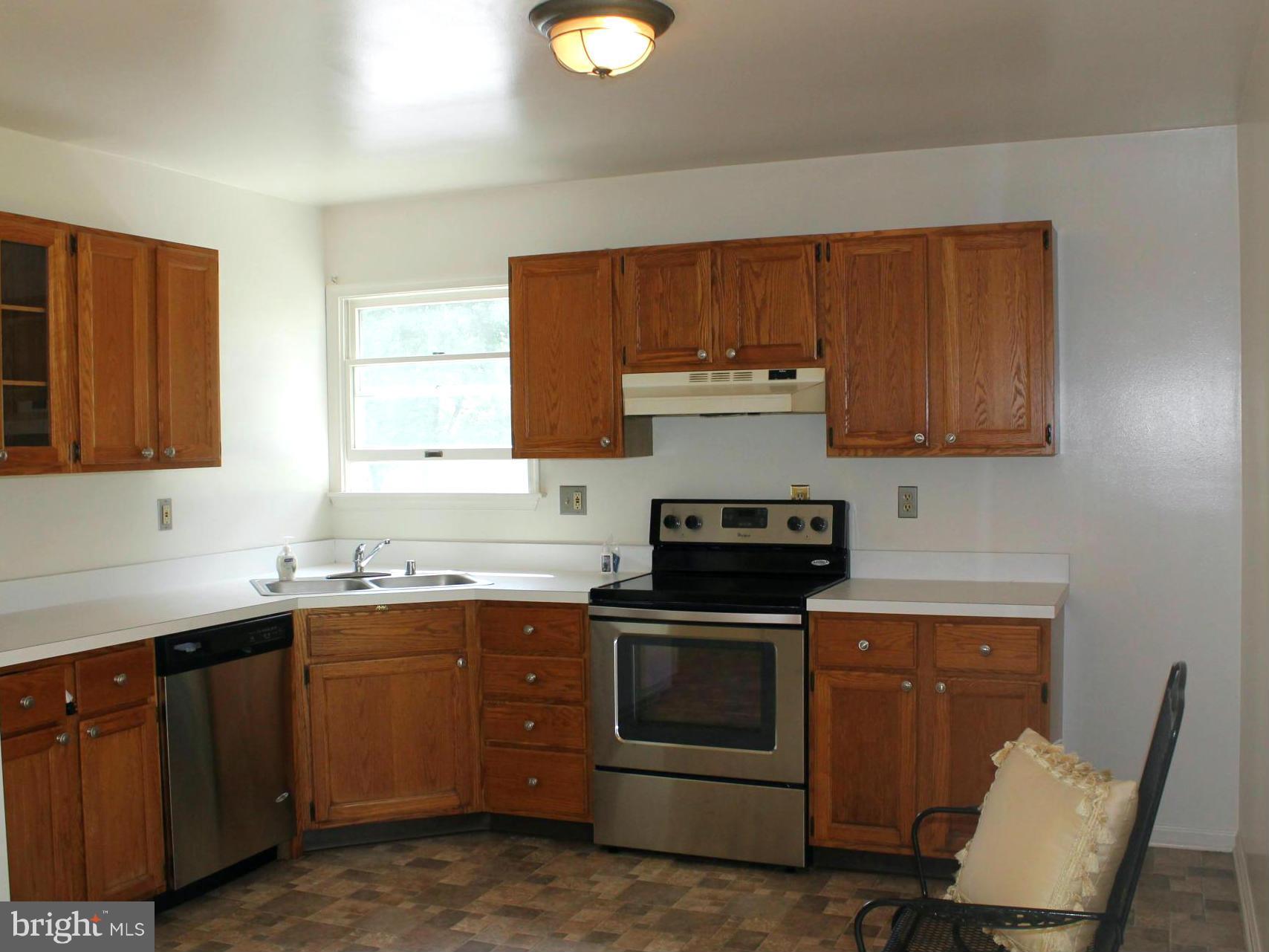 15405 Dover Road Upperco, MD 21155 - Photo 5 of 22 a kitchen with a sink and wooden cabinets