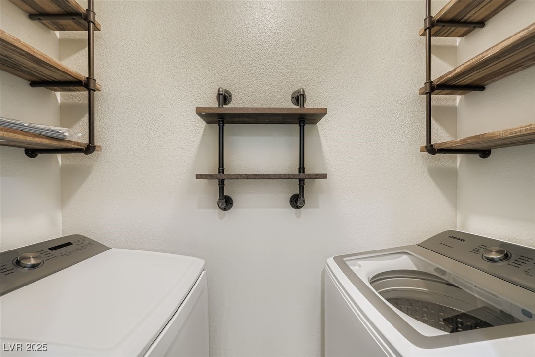 10550 West Alexander Road, Unit 2219 Las Vegas, NV 89129 - Photo 21 of 29 Laundry area with washing machine and clothes dryer and a textured wall