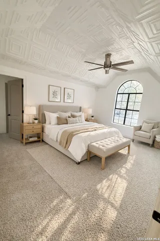 a bedroom with a bed couch and window