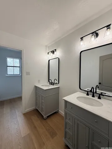 a bathroom with a double vanity sink and mirror