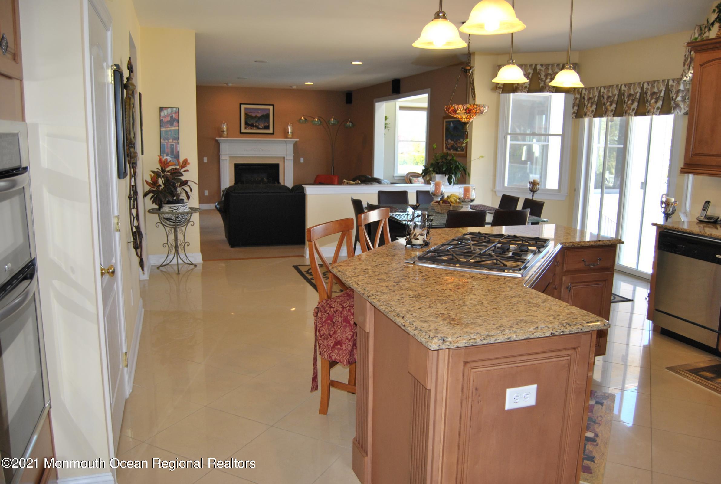 2 Hanging Rock Road Freehold, NJ 07728 - Photo 14 of 55 a living room with furniture a chandelier a large window and flat screen tv