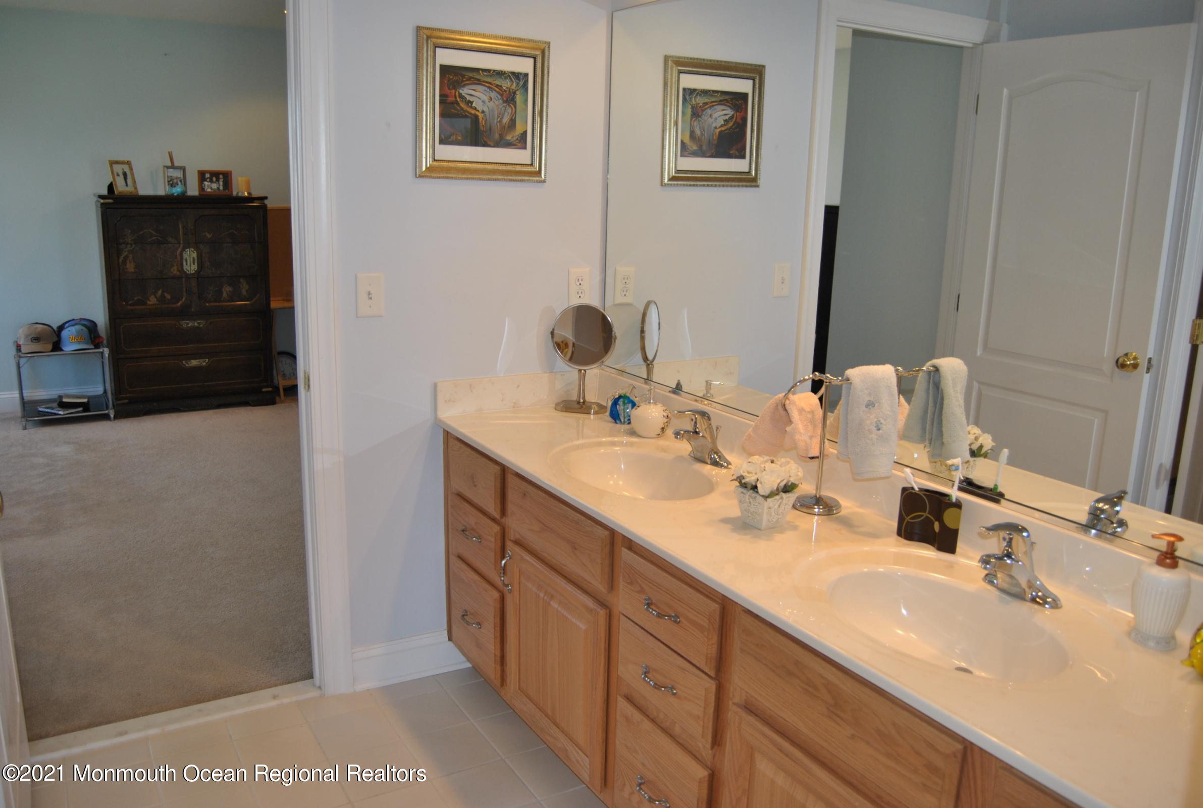 2 Hanging Rock Road Freehold, NJ 07728 - Photo 22 of 55 a bathroom with a double vanity sink and mirror