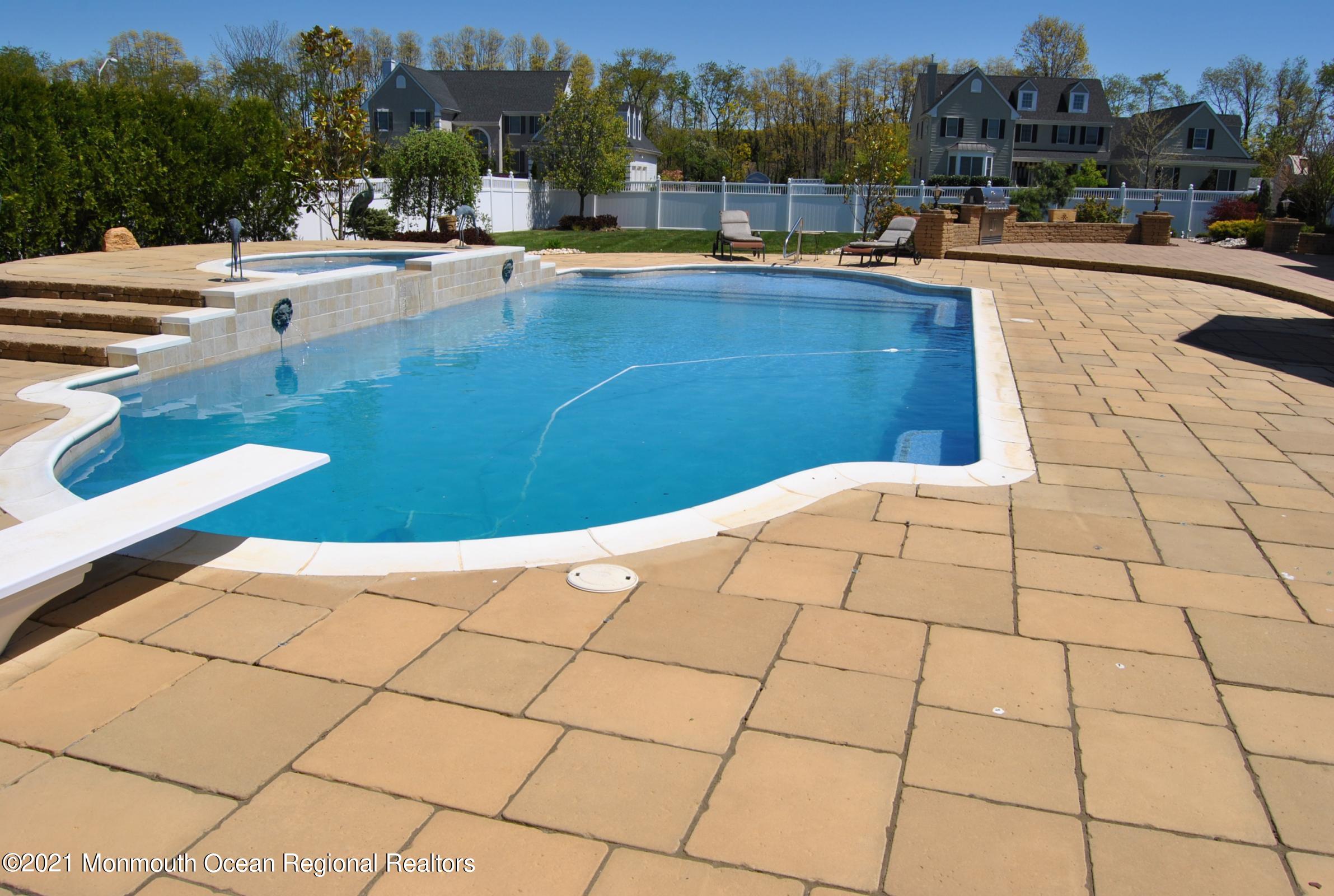 2 Hanging Rock Road Freehold, NJ 07728 - Photo 34 of 55 a view of swimming pool outdoor seating and city view