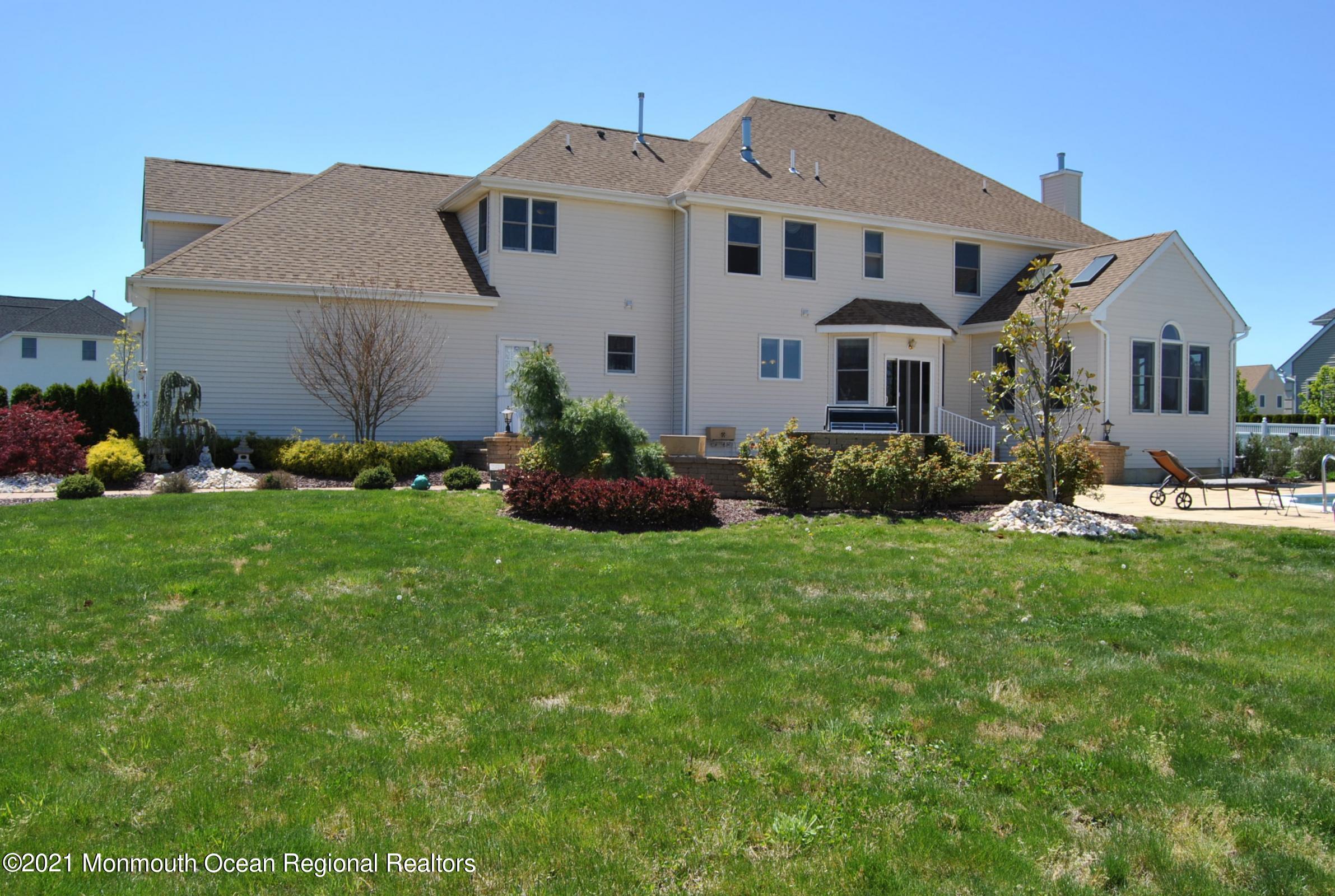 2 Hanging Rock Road Freehold, NJ 07728 - Photo 36 of 55 a front view of a house with a garden and plants