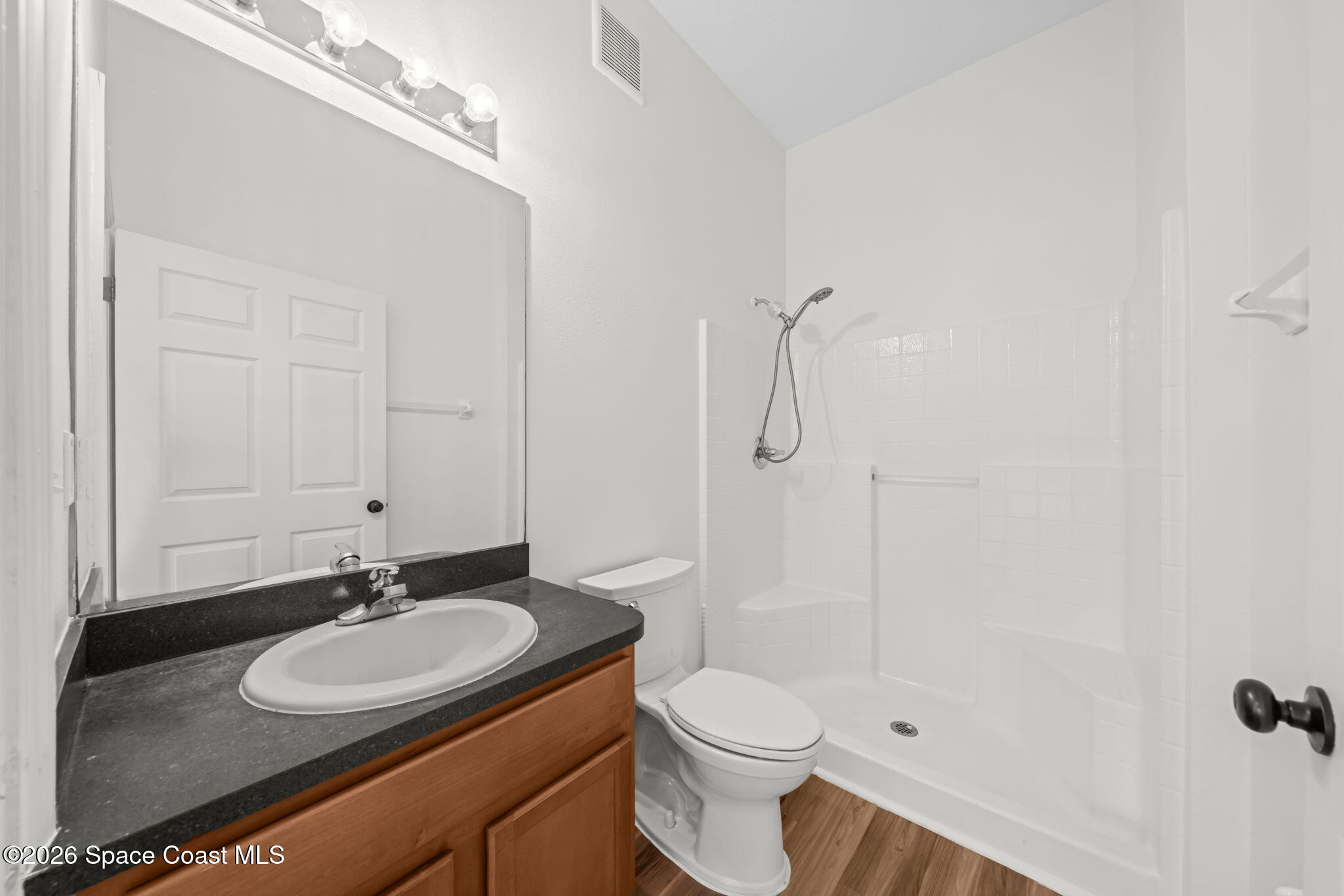 4056 Meander Place, Unit 104 Rockledge, FL 32955 - Photo 11 of 25 a bathroom with a sink toilet a mirror and shower