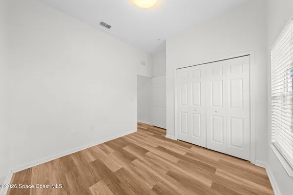 an aerial view of residential houses with outdoor space and parking