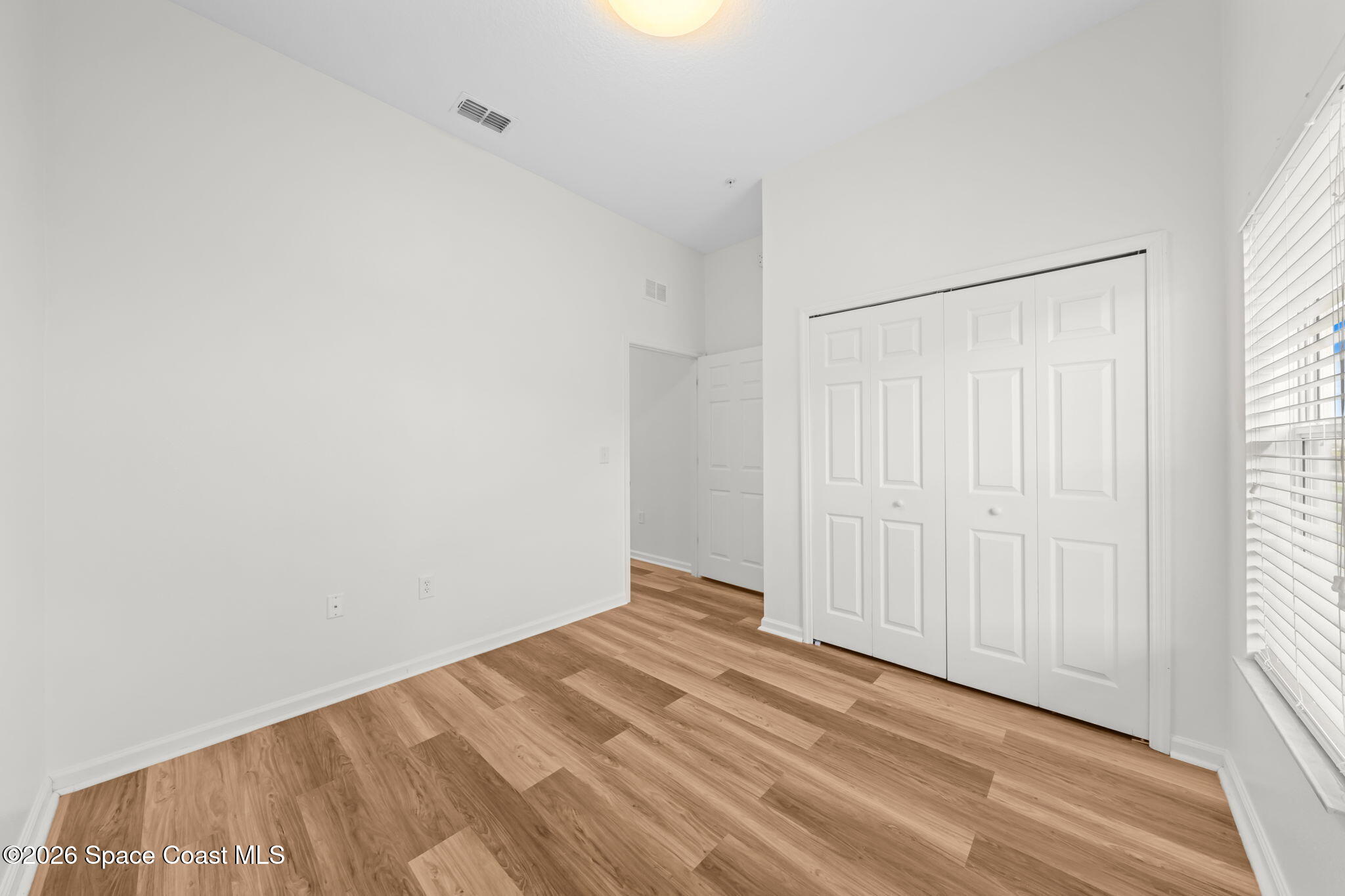 4056 Meander Place, Unit 104 Rockledge, FL 32955 - Photo 12 of 25 a view of a room with wooden floor and a window