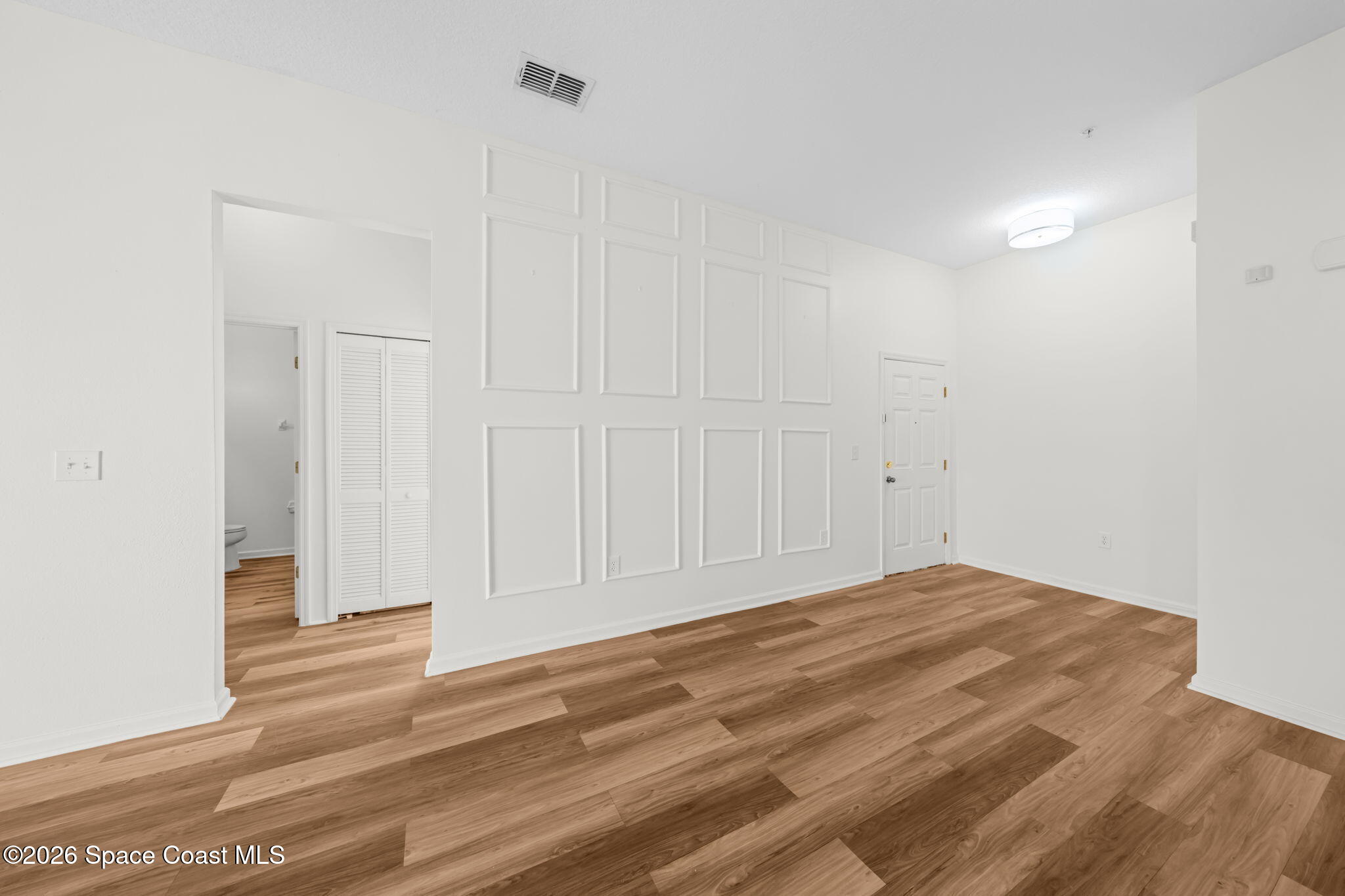 4056 Meander Place, Unit 104 Rockledge, FL 32955 - Photo 16 of 25 a view of empty room with wooden floor