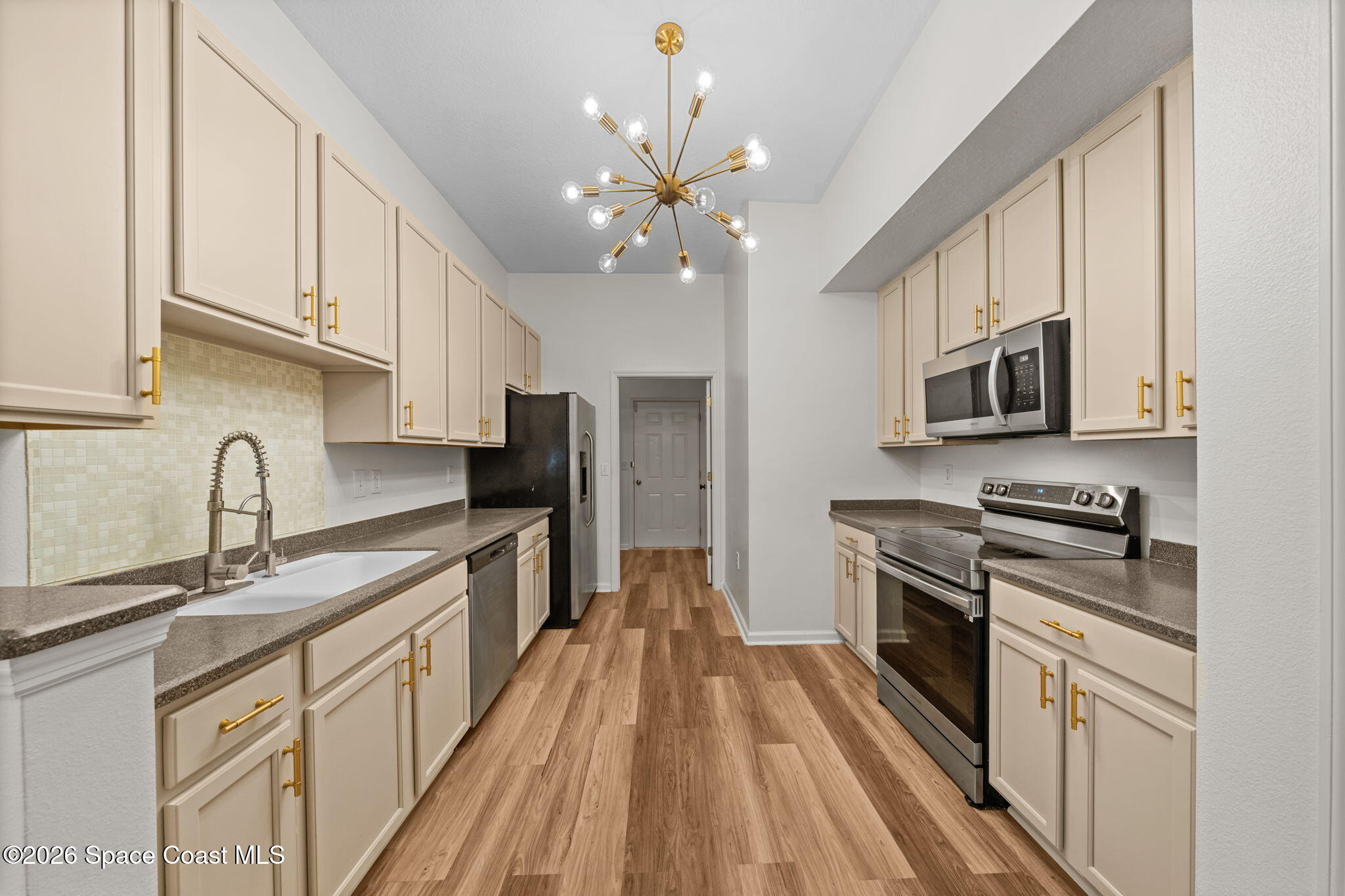 4056 Meander Place, Unit 104 Rockledge, FL 32955 - Photo 2 of 25 a kitchen with stainless steel appliances granite countertop a sink dishwasher stove top oven and refrigerator