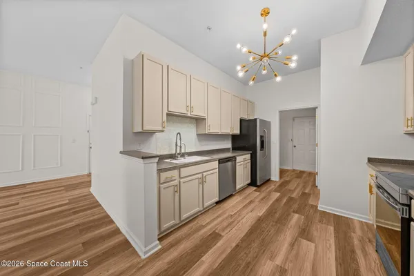 a view of empty room with wooden floor and window