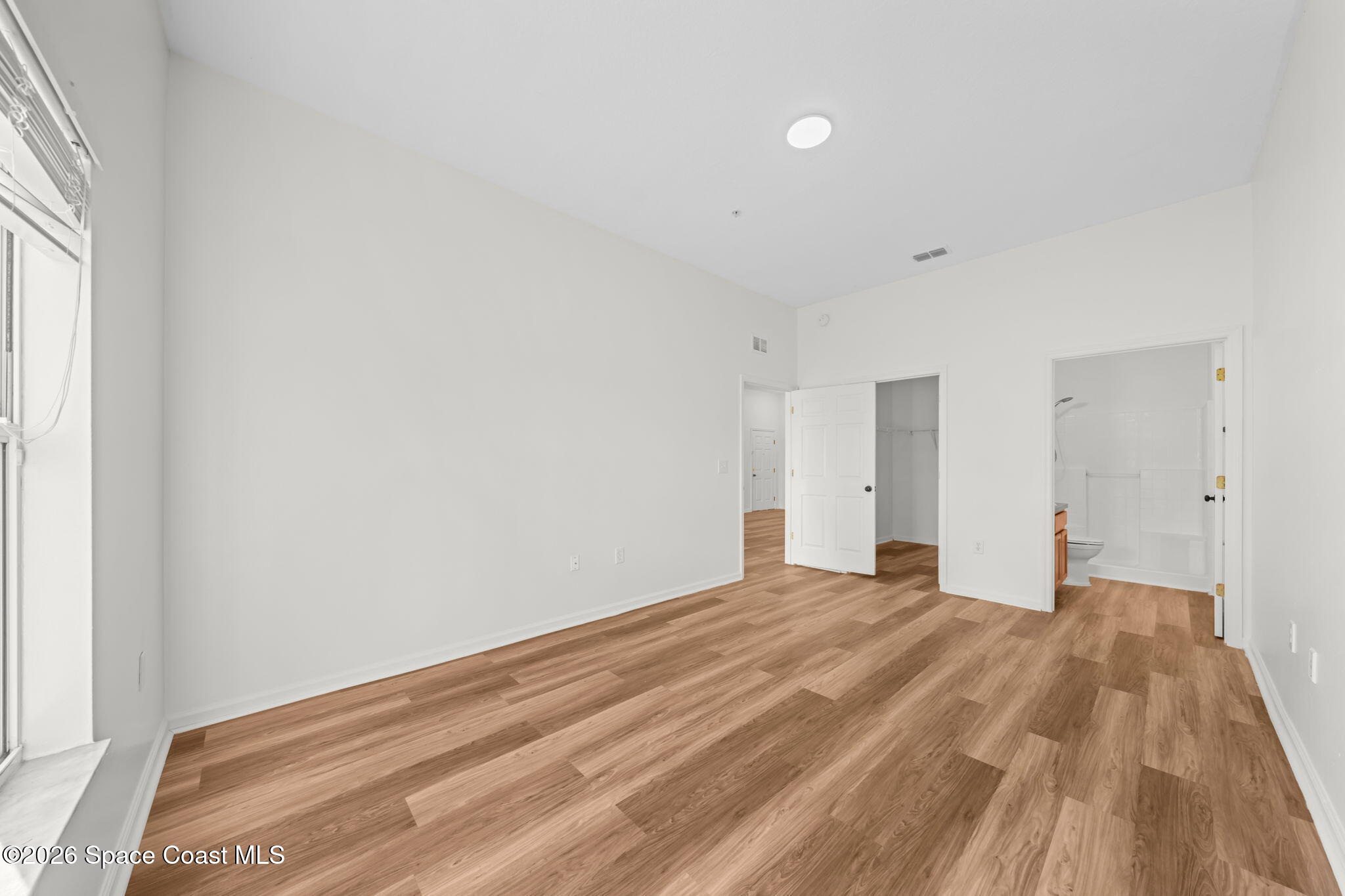 4056 Meander Place, Unit 104 Rockledge, FL 32955 - Photo 9 of 25 a view of empty room with wooden floor and fan