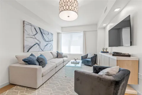 a kitchen with a dining table chairs and wooden floor