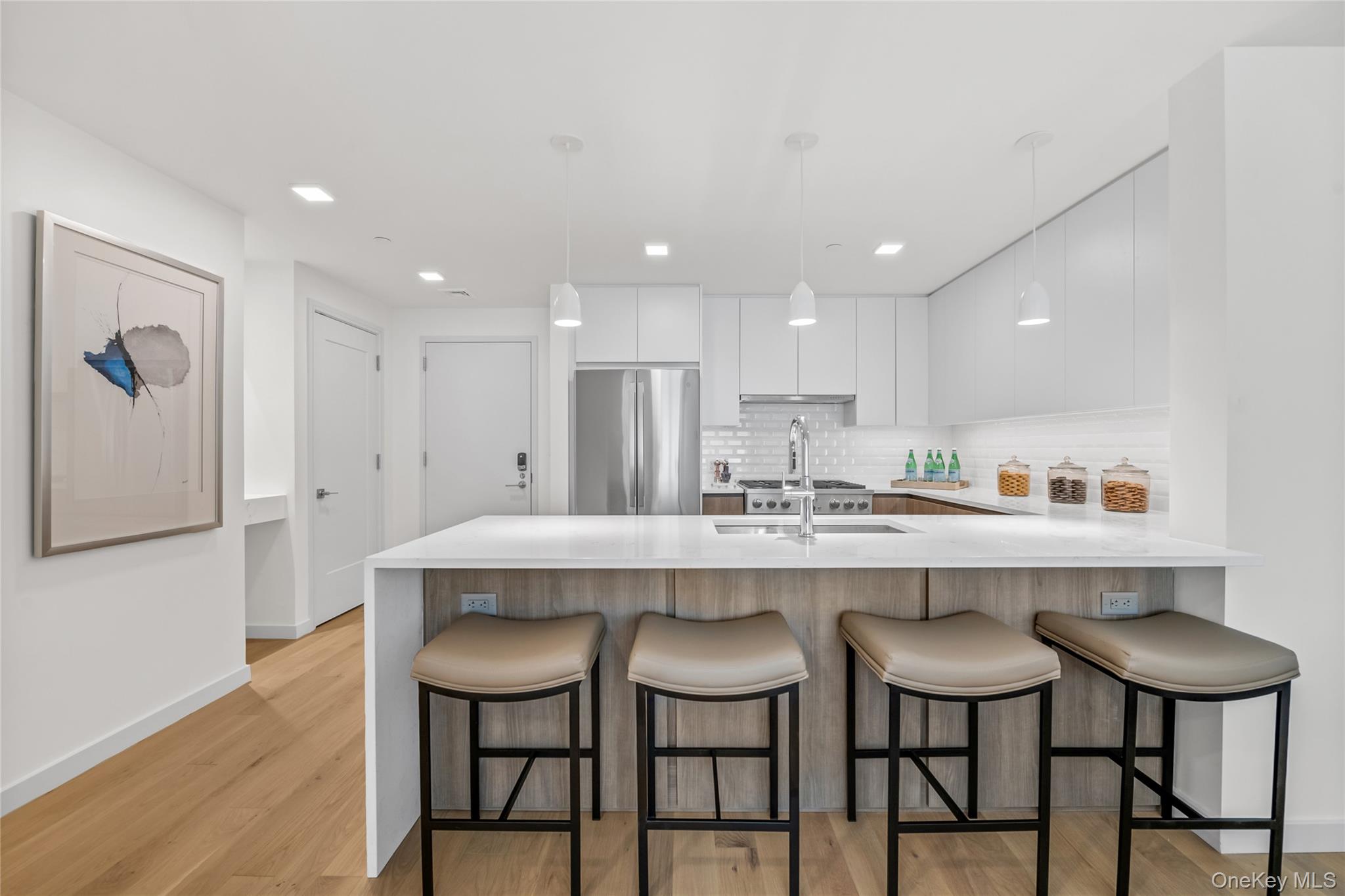 218 Middle Neck Road, Unit 207 Great Neck, NY 11021 - Photo 20 of 32 a kitchen with a dining table chairs and wooden floor