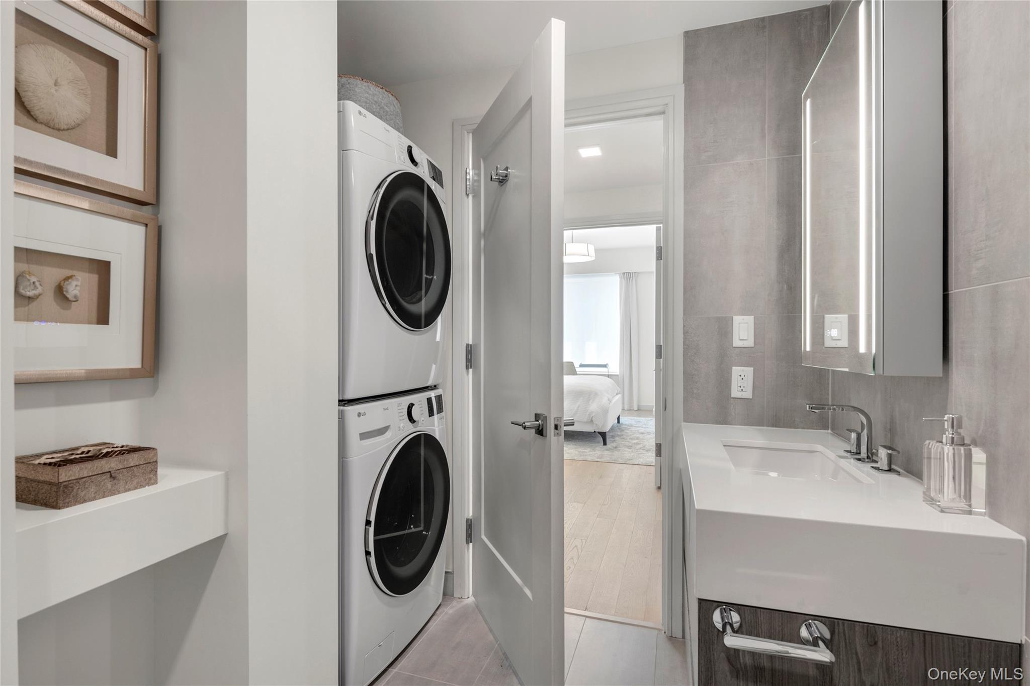 218 Middle Neck Road, Unit 207 Great Neck, NY 11021 - Photo 23 of 32 a utility room with sink dryer and washer