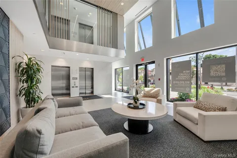 a living room with patio furniture and a potted plant
