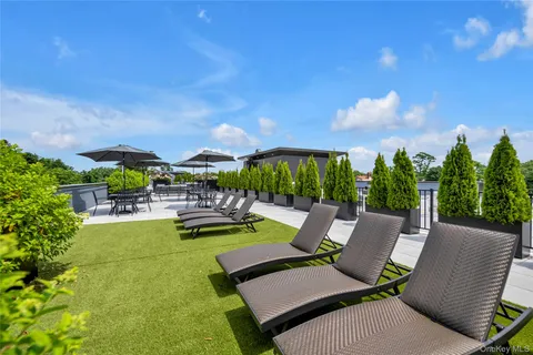a view of swimming pool with seating area and garden