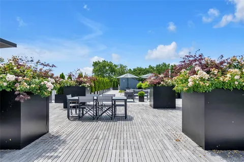 a balcony with furniture and a potted plant
