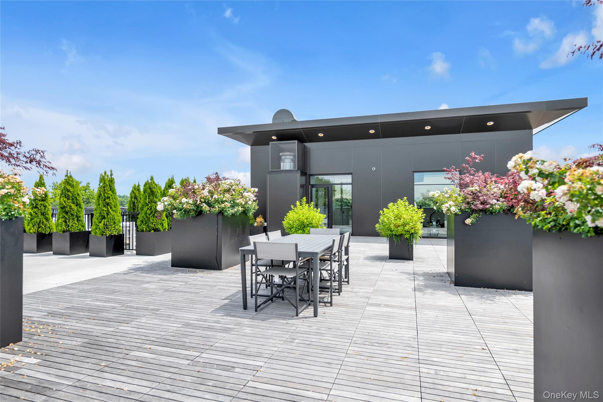 218 Middle Neck Road, Unit 207 Great Neck, NY 11021 - Photo 10 of 32 a view of a chairs and table in a patio