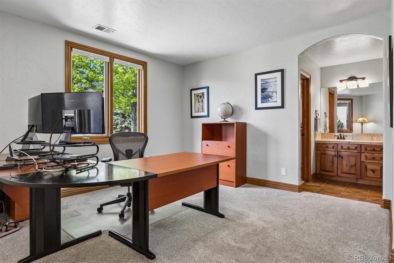 16422 Rocky Point Lane Morrison, CO 80465 - Photo 35 of 50 a view of a workspace with furniture and a window
