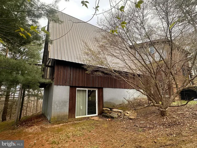 a view of dirt yard with a tree