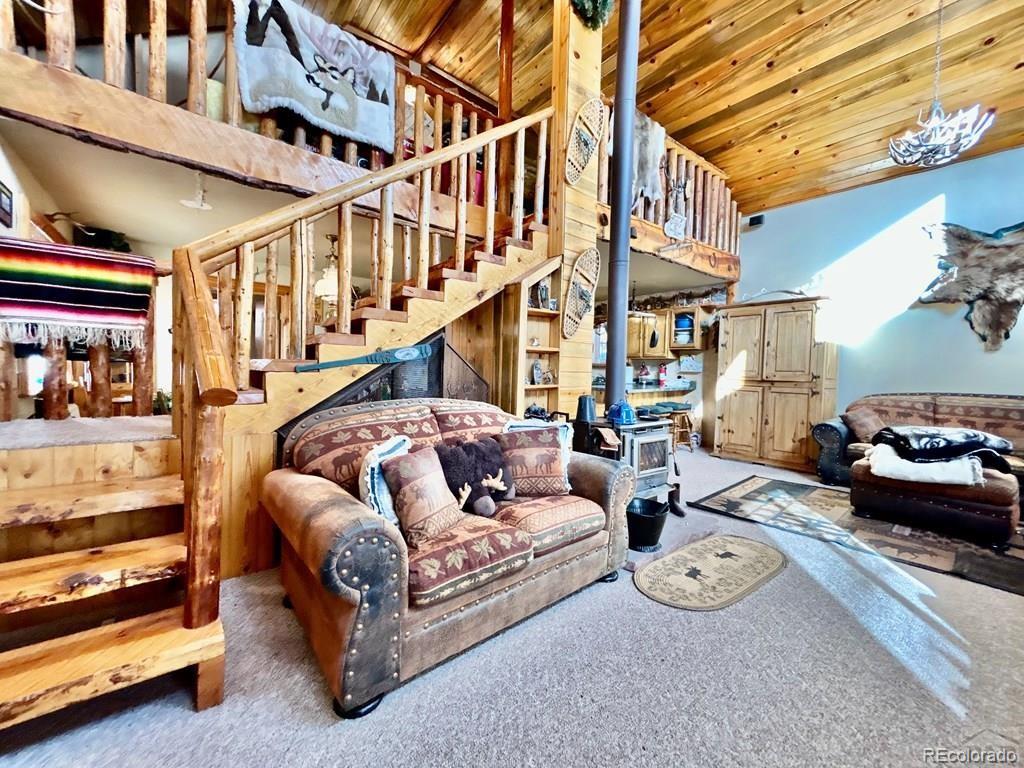 10401 Windy Ridge Road Aguilar, CO 81020 - Photo 3 of 24 a view of a patio with couches and a table and chairs with wooden floor