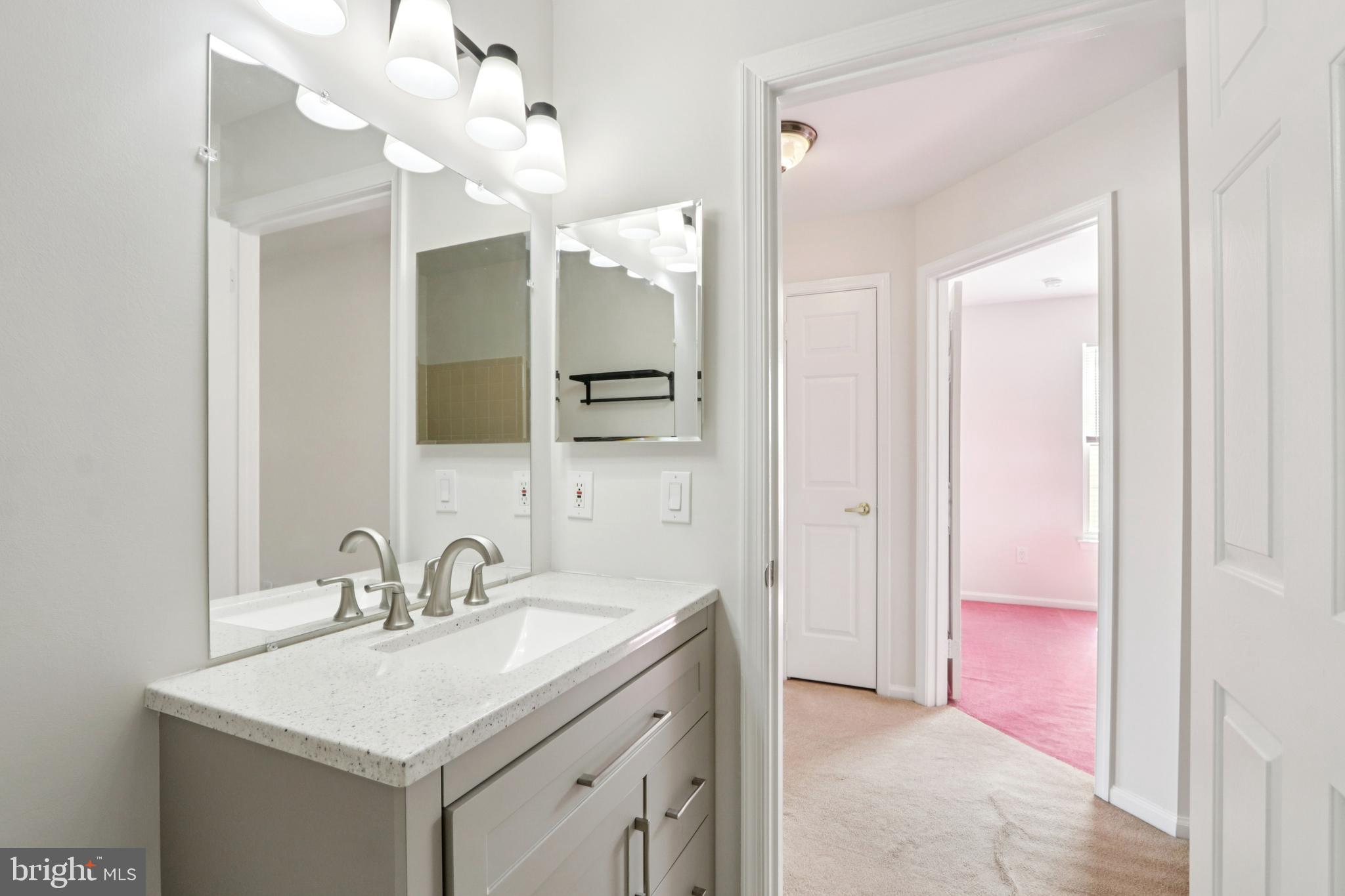 58 Watson Drive Mount Laurel, NJ 08054 - Photo 30 of 56 a bathroom with a sink a vanity a mirror and a light fixture