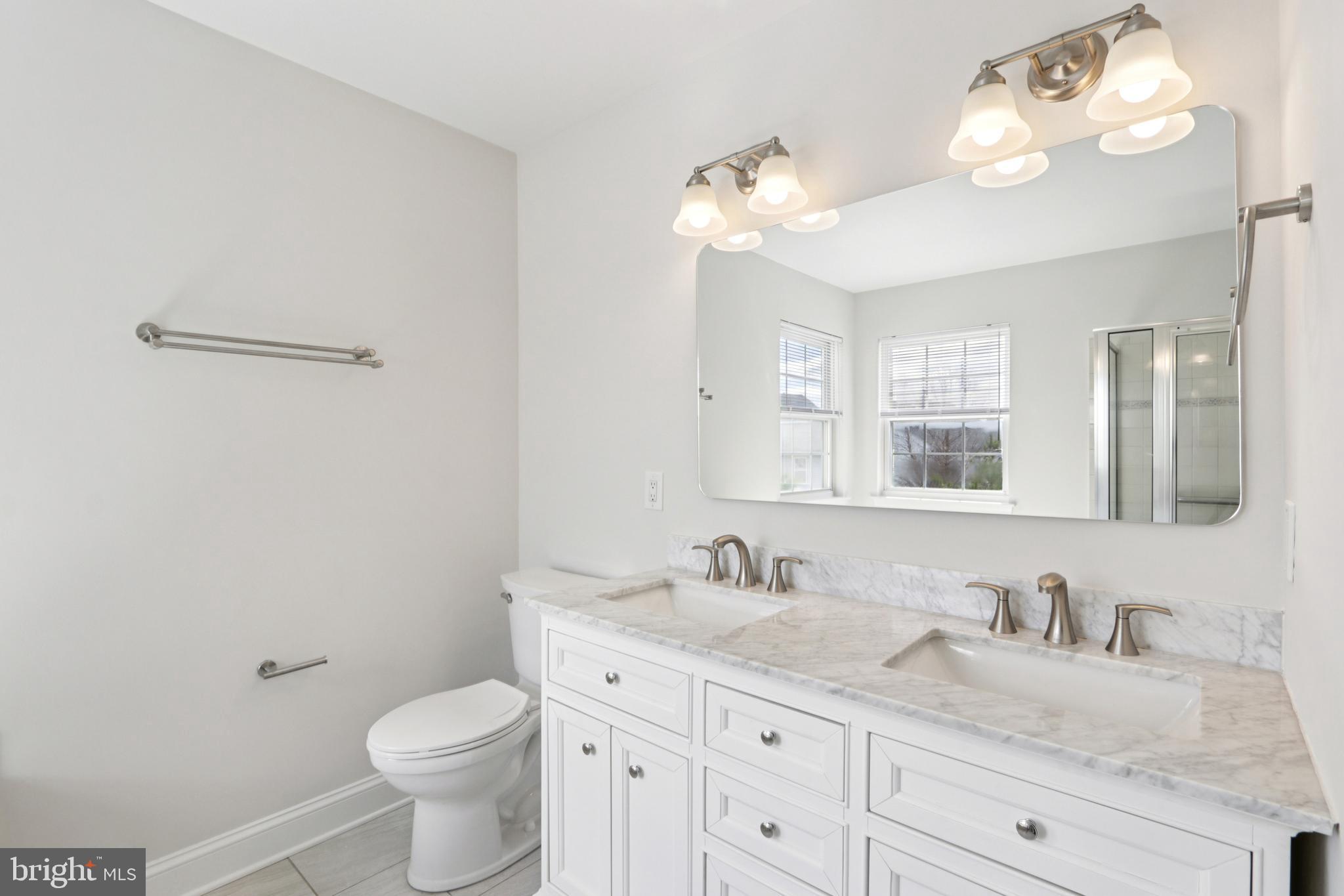 58 Watson Drive Mount Laurel, NJ 08054 - Photo 37 of 56 a bathroom with a granite countertop sink a toilet and a mirror