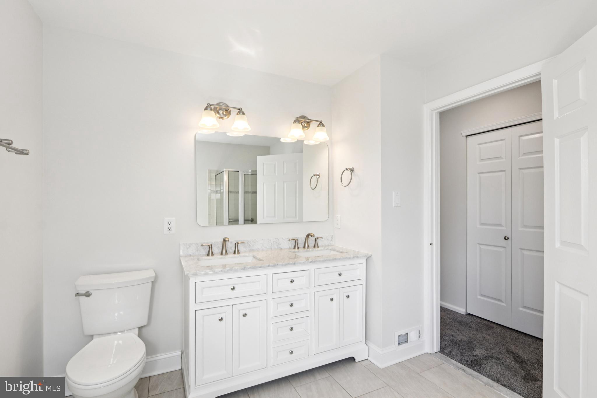 58 Watson Drive Mount Laurel, NJ 08054 - Photo 39 of 56 a bathroom with a double vanity sink a mirror and a toilet