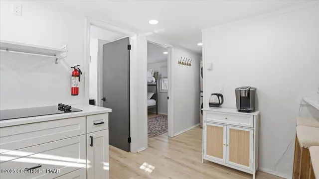 a view of a house with a large window and wooden fence