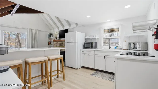 a view of a patio with a table chairs and a yard