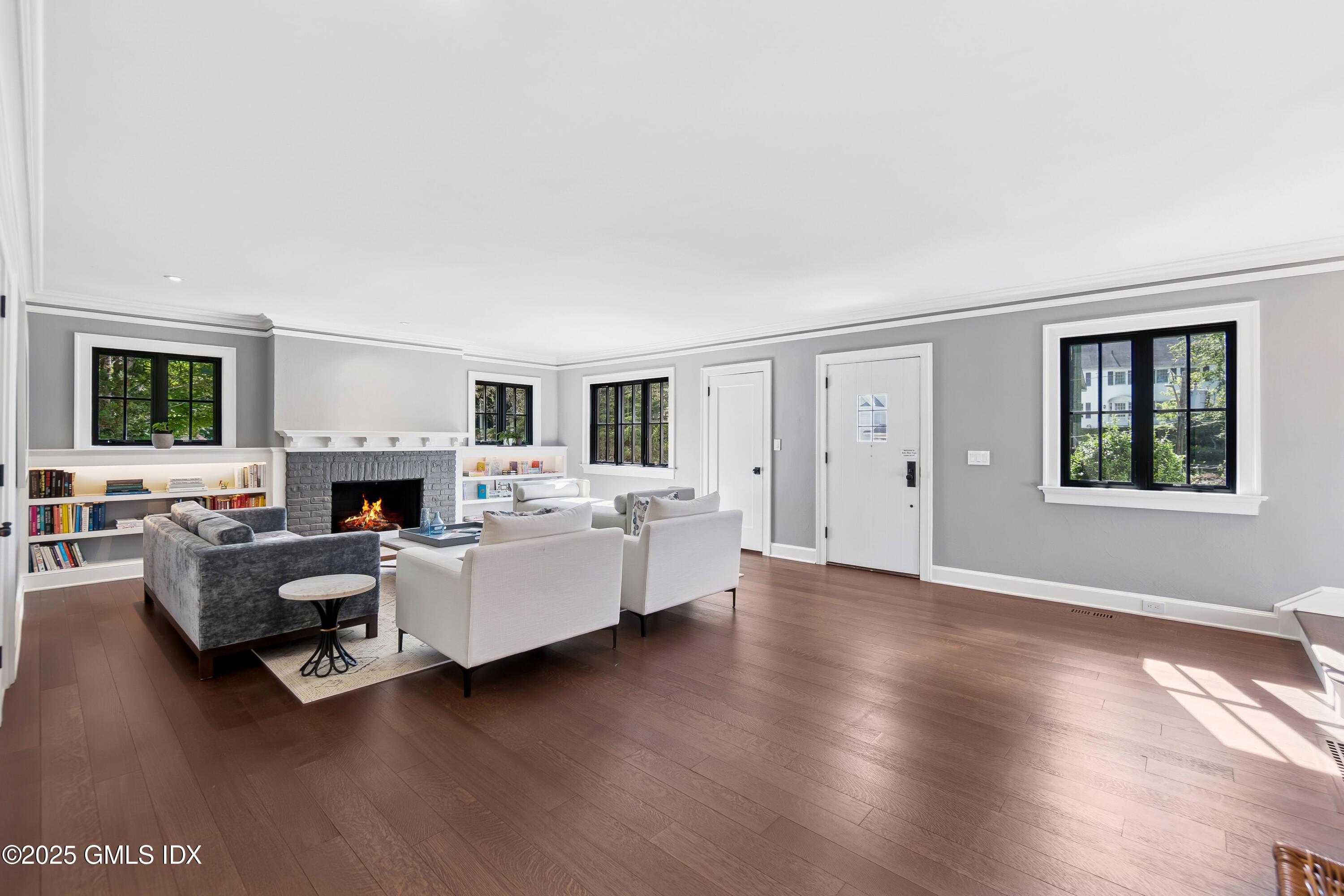 87 Orchard Drive Greenwich, CT 06830 - Photo 11 of 31 a living room with furniture a fireplace and a large window