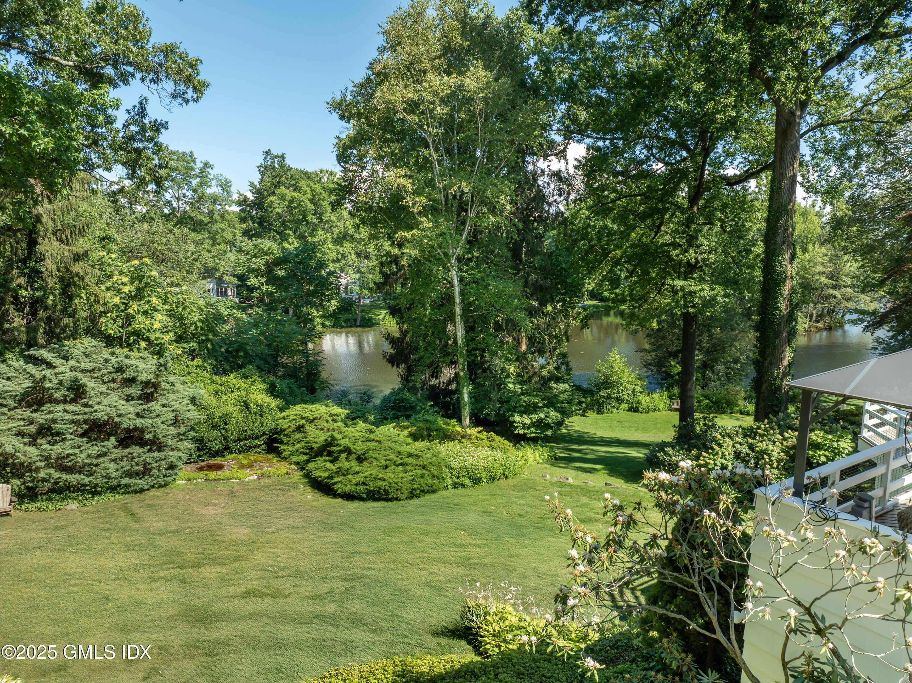 87 Orchard Drive Greenwich, CT 06830 - Photo 25 of 31 a view of a garden with a fountain