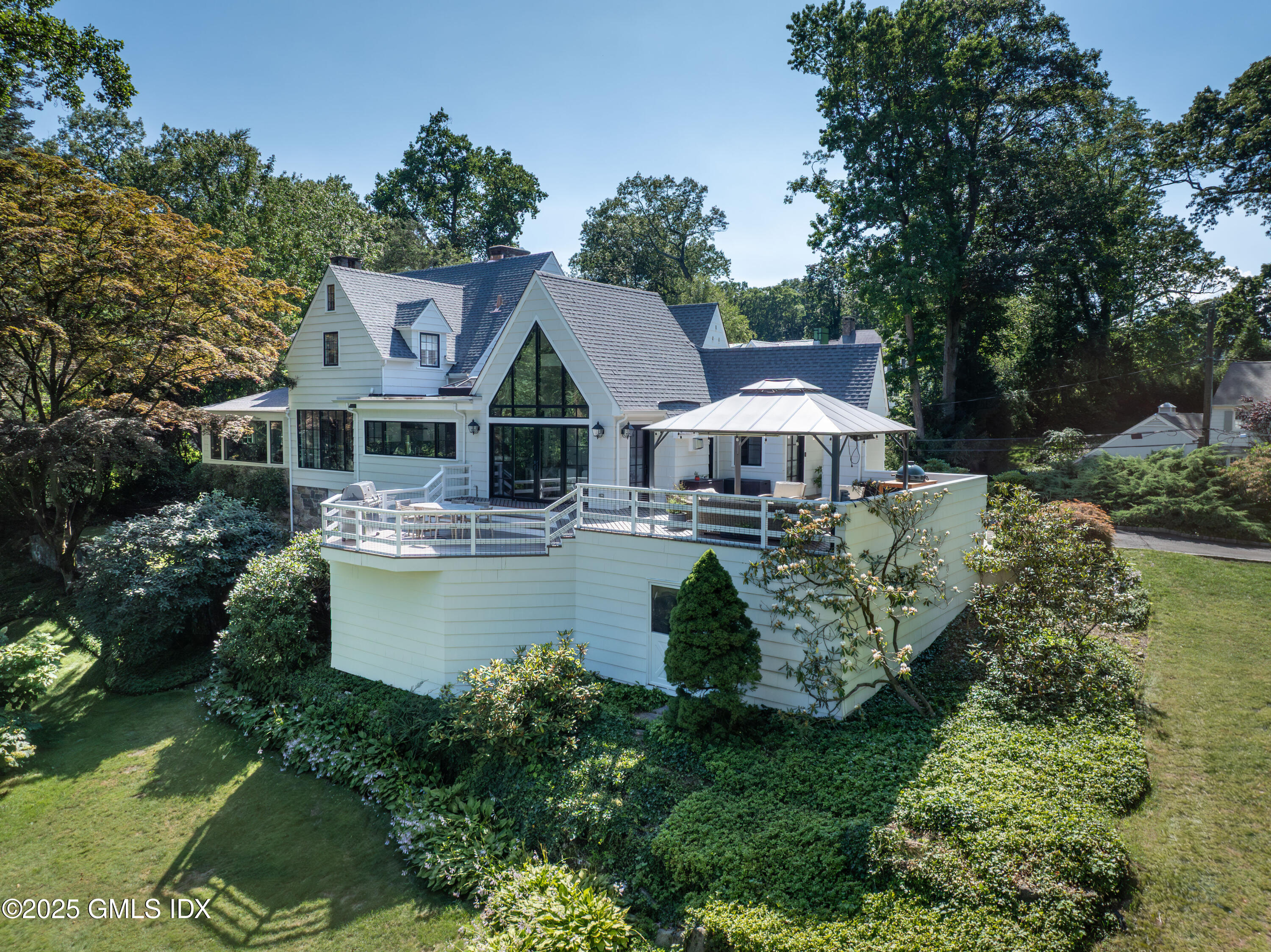 87 Orchard Drive Greenwich, CT 06830 - Photo 27 of 31 a front view of a house with garden