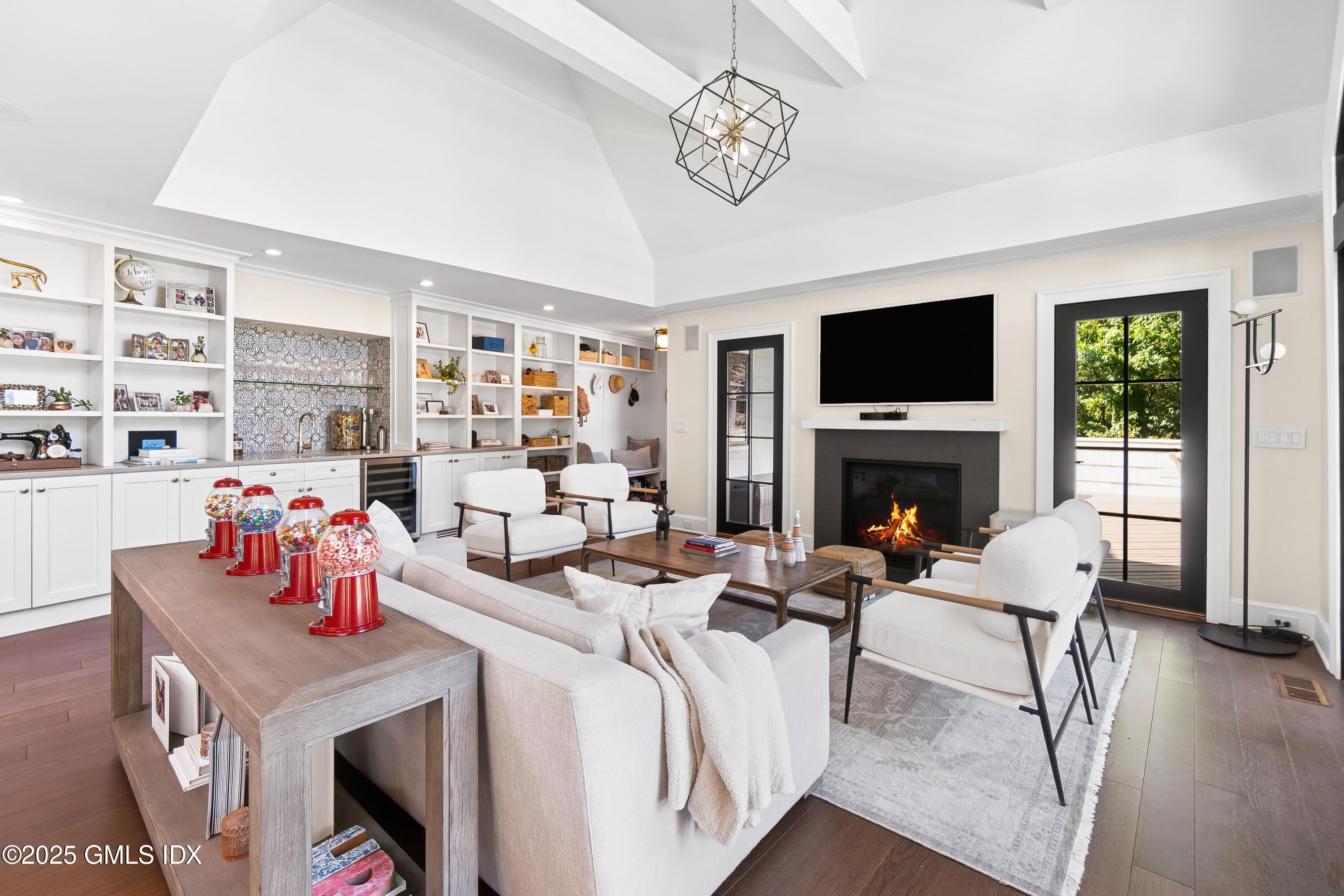 87 Orchard Drive Greenwich, CT 06830 - Photo 5 of 31 a living room with furniture a fireplace and a flat screen tv