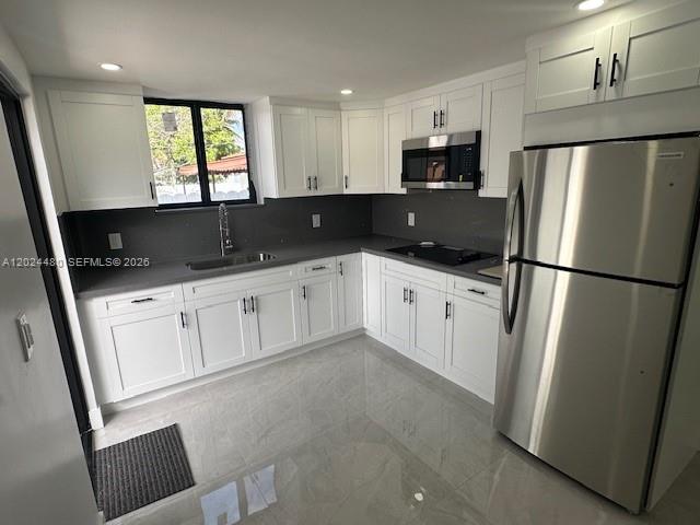 11870 Southwest 5th Street, Unit A Miami, FL 33184 - Photo 4 of 18 a kitchen with granite countertop white cabinets and refrigerator