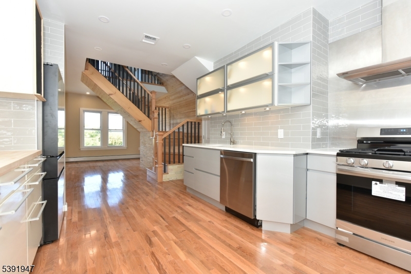 a kitchen with stainless steel appliances granite countertop a stove and a sink