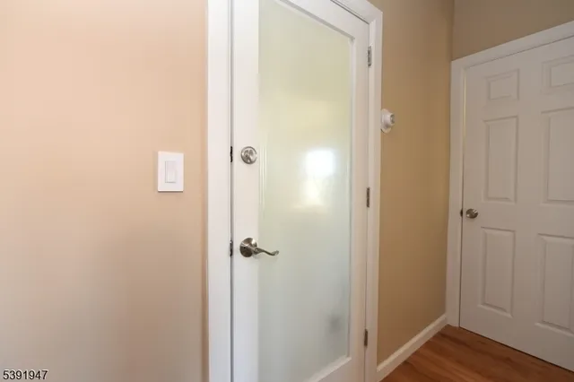 a view of an entryway with wooden floor