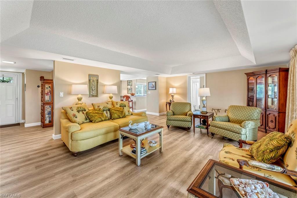 245 Quails Nest Road, Unit 3 Naples, FL 34112 - Photo 17 of 50 a living room with furniture and a wooden floor