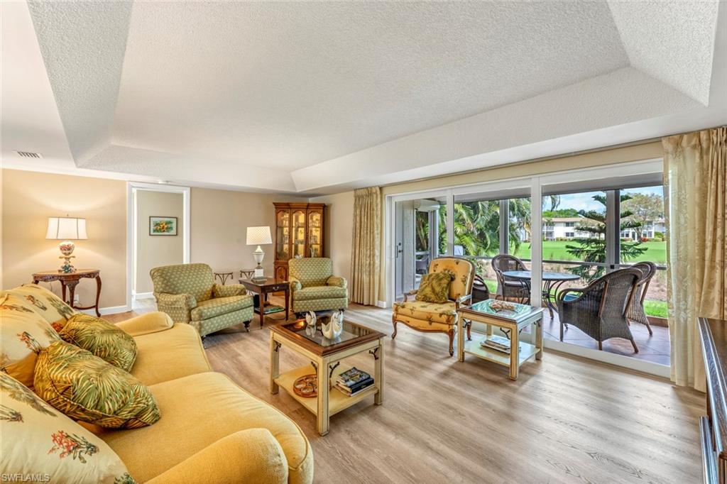 245 Quails Nest Road, Unit 3 Naples, FL 34112 - Photo 18 of 50 a living room with furniture and floor to ceiling windows
