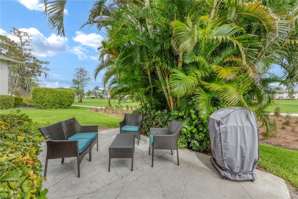 245 Quails Nest Road, Unit 3 Naples, FL 34112 - Photo 2 of 50 a view of a chairs and table in a yard
